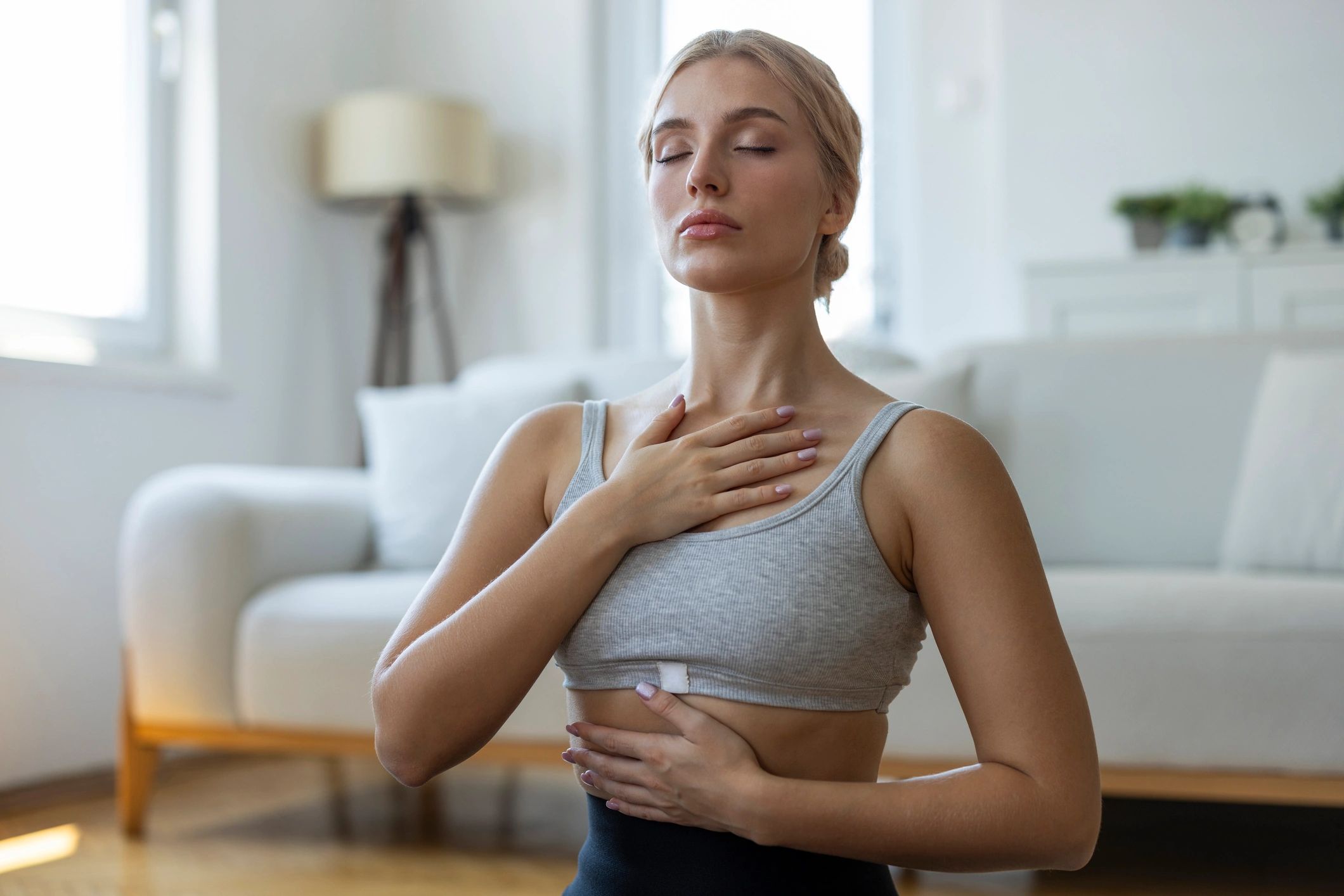 Woman practicing mindfulness and conscious breathing at home